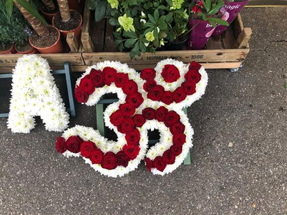Actual Van Arthur Hindu Om Aum tribute made with red roses and white chrysanthemum edging