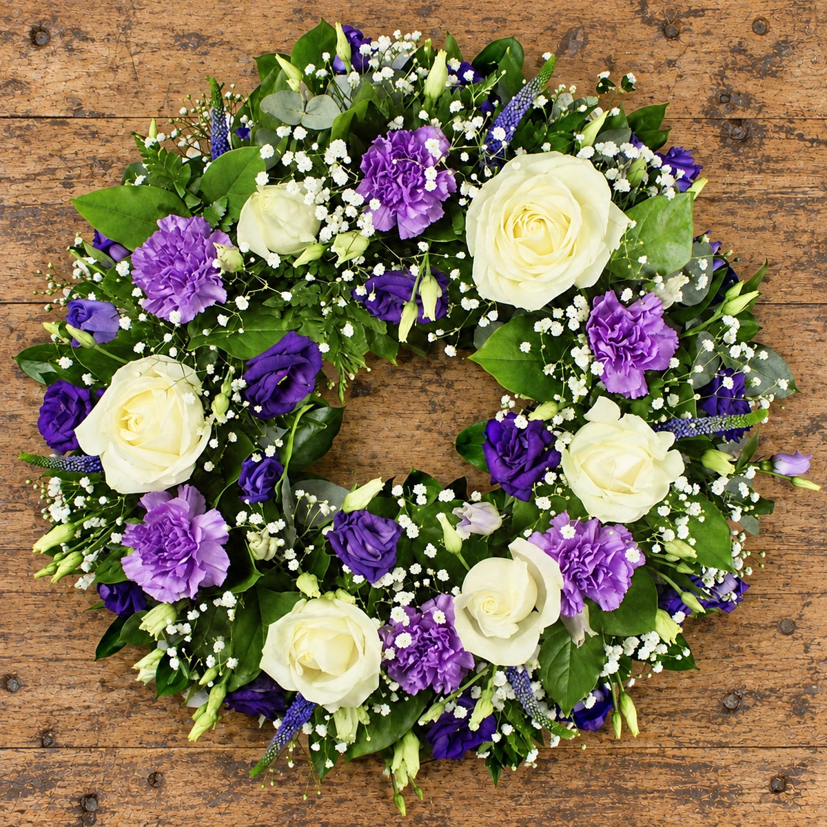 Purple & White Wreath — overhead workbench view