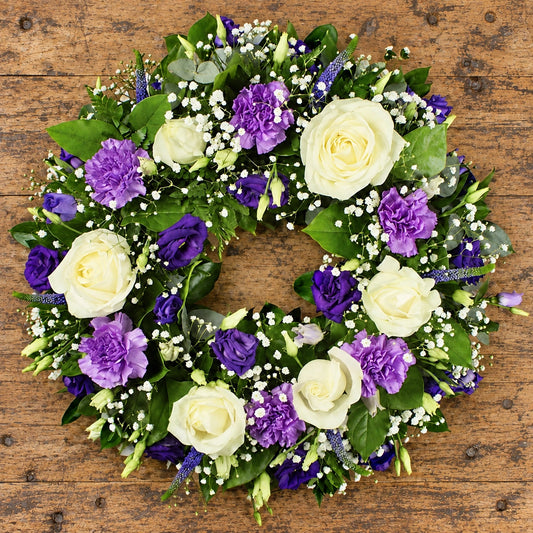 Purple & White Wreath — overhead workbench view
