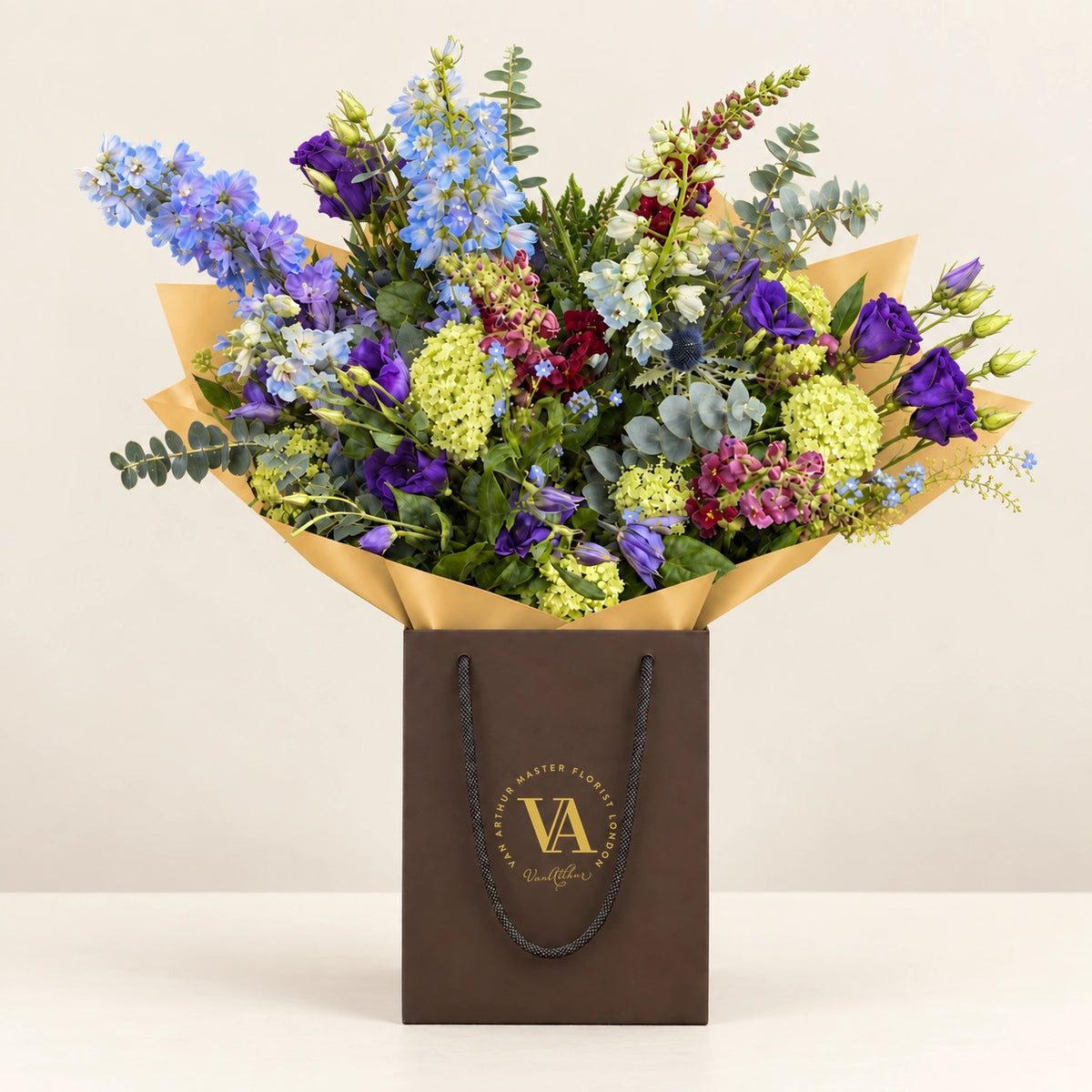 Violet by Van Arthur Master Florist — the bouquet in signature packaging against a quiet backdrop.
