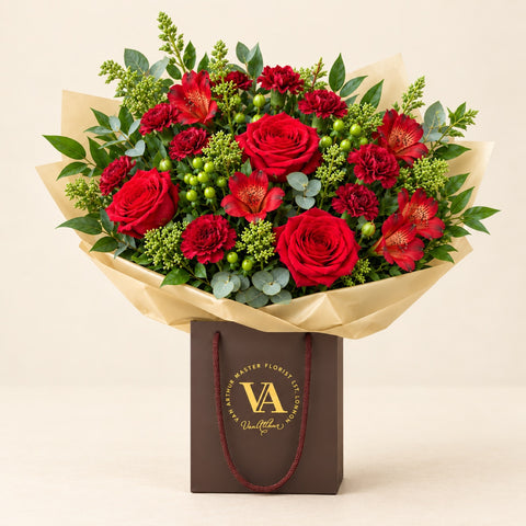 Red and green Artisan bouquet in Van Arthur packaging