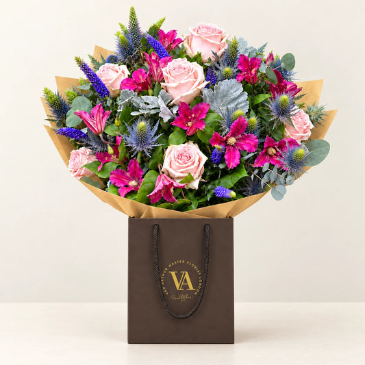 Florence by Van Arthur Master Florist — the bouquet in signature packaging against a quiet backdrop.