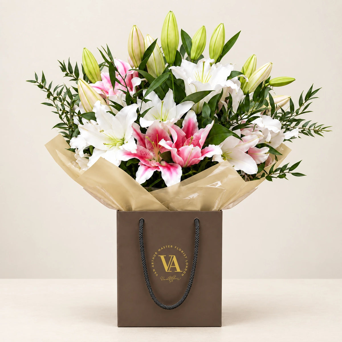 Lilian by Van Arthur Master Florist — the bouquet in signature packaging against a quiet backdrop.
