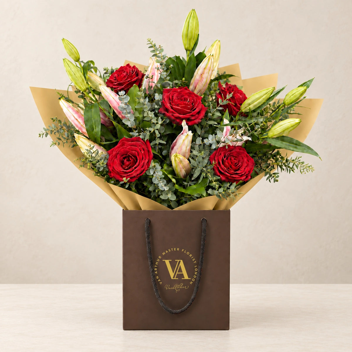 Oriental Lily and Rose Bouquet by Van Arthur Master Florist — the bouquet in signature packaging against a quiet backdrop.