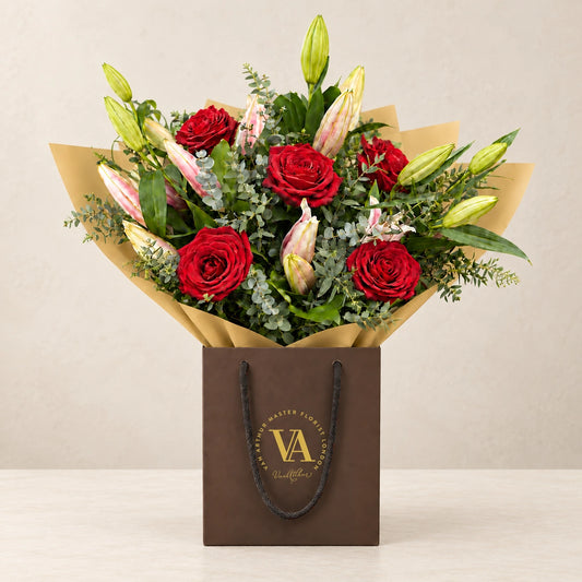 Oriental Lily and Rose Bouquet by Van Arthur Master Florist — the bouquet in signature packaging against a quiet backdrop.