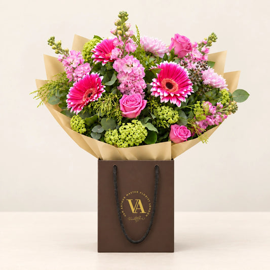 Isla by Van Arthur Master Florist — the bouquet in signature packaging against a quiet backdrop.